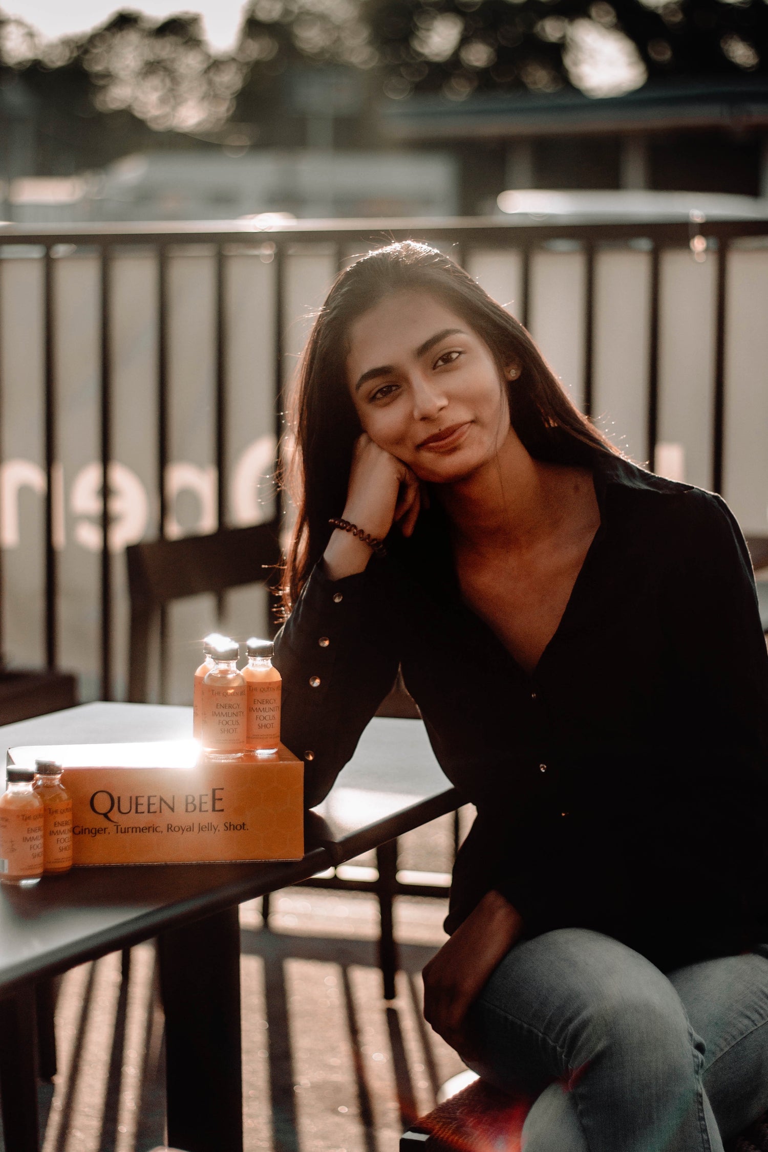 girl sitting on chair next to wellness shots