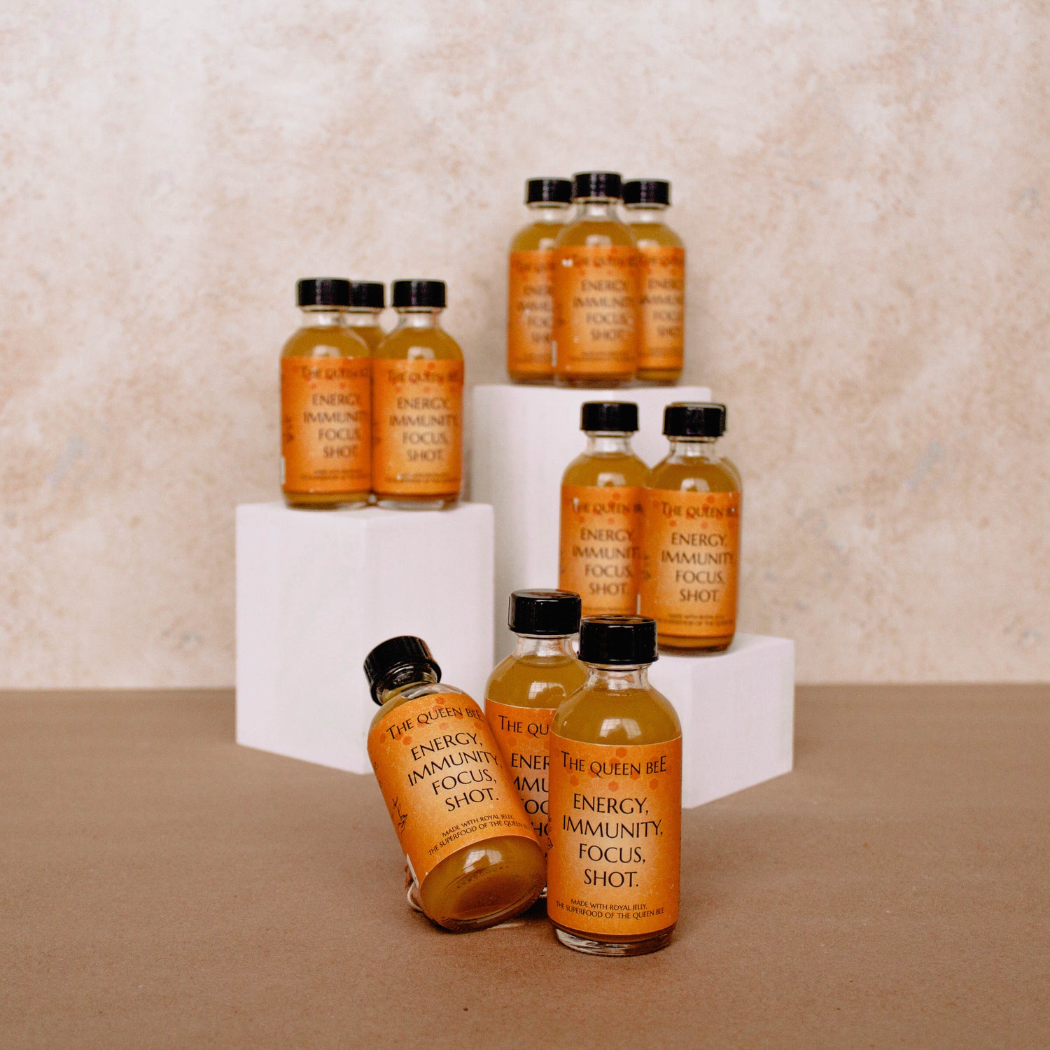 Photo of our 12 pack wellness shot, expertly formulated with just 6 ingredients sourced furor 4 continents around the world. Freshly juiced ginger from Peru, turmeric from India, lemons from Florida, cayenne from Japan, royal jelly from the Amazon rainforest, and buckwheat honey straight from our local bee farms.